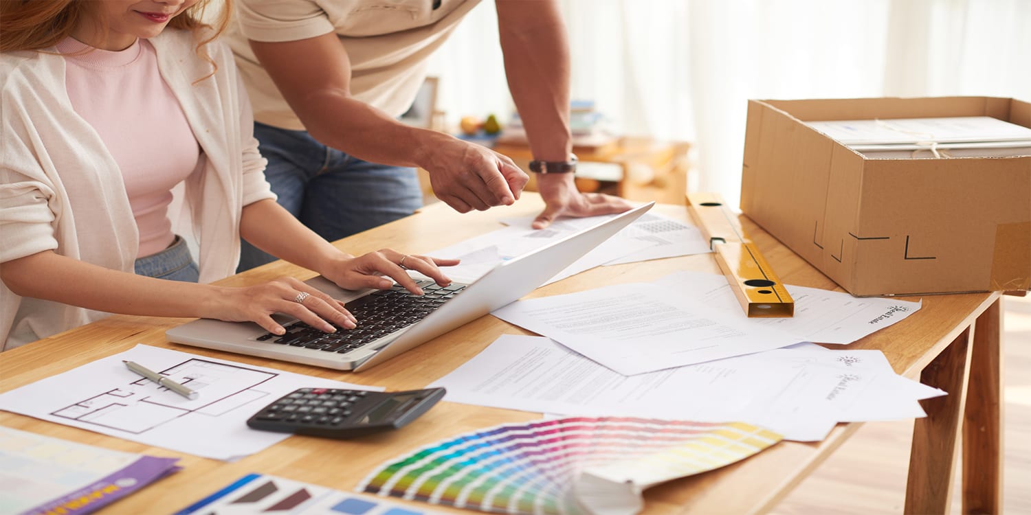 Real estate investors performing property analytics and renovation budget